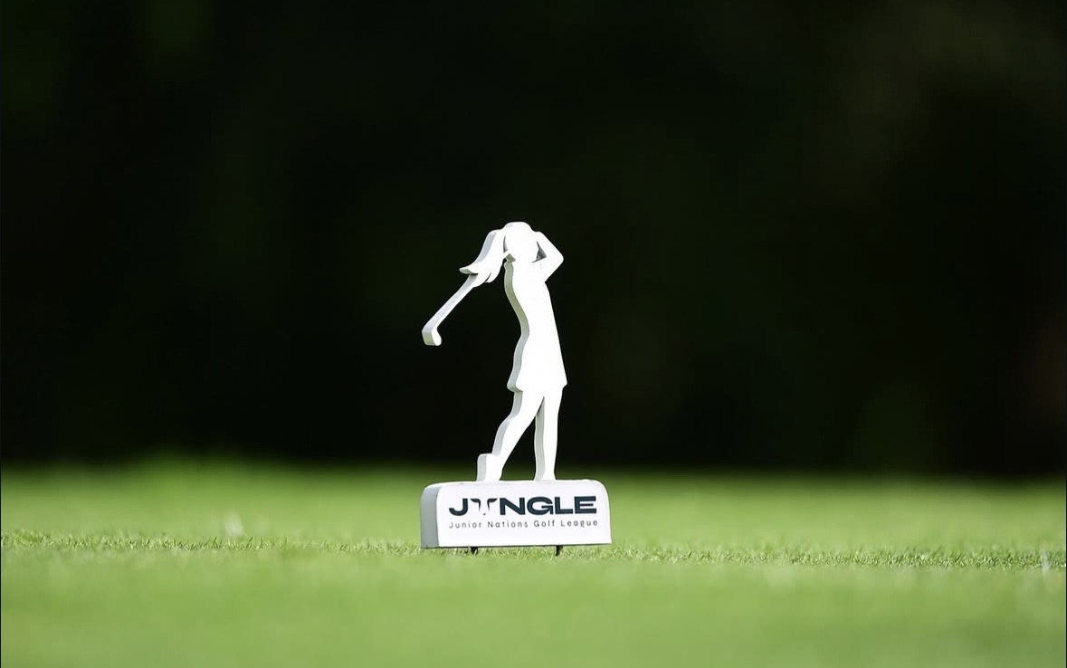 Jungle junior golf trophy figurine on the fairway at sunset.